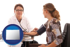 colorado map icon and a female nurse practitioner checking a patient's blood pressure