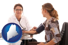 maine map icon and a female nurse practitioner checking a patient's blood pressure
