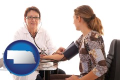 nebraska map icon and a female nurse practitioner checking a patient's blood pressure