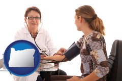 oregon map icon and a female nurse practitioner checking a patient's blood pressure