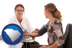 south-carolina map icon and a female nurse practitioner checking a patient's blood pressure