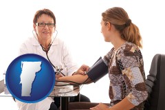 vermont map icon and a female nurse practitioner checking a patient's blood pressure