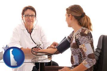 a female nurse practitioner checking a patient's blood pressure - with Delaware icon