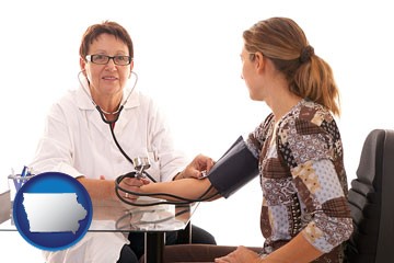 a female nurse practitioner checking a patient's blood pressure - with Iowa icon