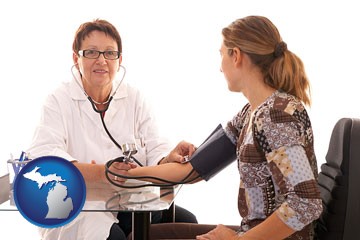 a female nurse practitioner checking a patient's blood pressure - with Michigan icon