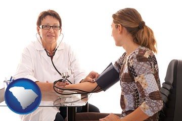 a female nurse practitioner checking a patient's blood pressure - with South Carolina icon